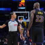 Nov 18, 2025; Los Angeles, California, USA; NBA female referee Sha'rae Mitchell (98) talks with Los Angeles Lakers forward LeBron James (23) in the second quarter of the game against the Utah Jazz at Crypto.com Arena. Mandatory Credit: Kirby Lee-Imagn Images