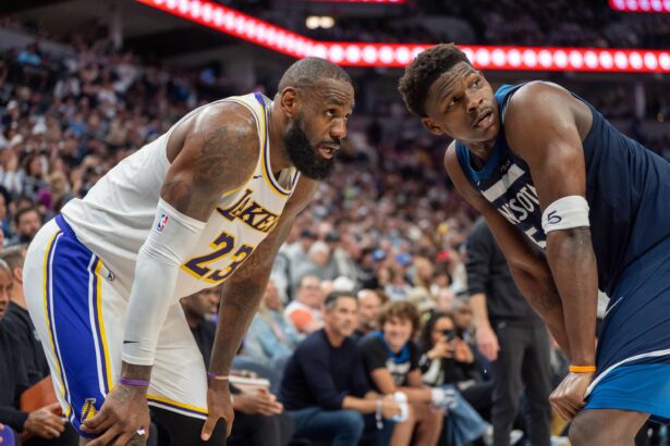 Minnesota Timberwolves guard Anthony Edwards (5) guards Los Angeles Lakers forward LeBron James (23) in the second quarter during game four of first round for the 2025 NBA Playoffs at Target Center.