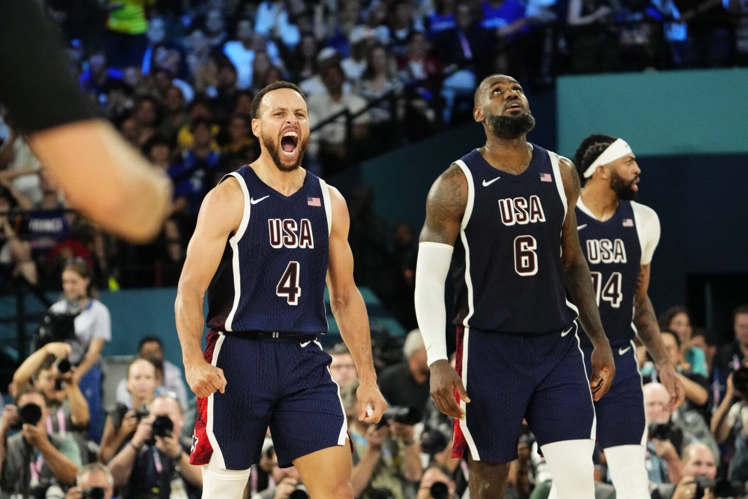 United States shooting guard Stephen Curry (4) and guard LeBron James (6) react in the second half against France in the men's basketball gold medal game during the Paris 2024 Olympic Summer Games at Accor Arena.