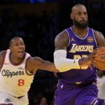 Los Angeles Lakers forward LeBron James (23) drives past Los Angeles Clippers guard Kris Dunn (8) during the first half at Crypto.com Arena.