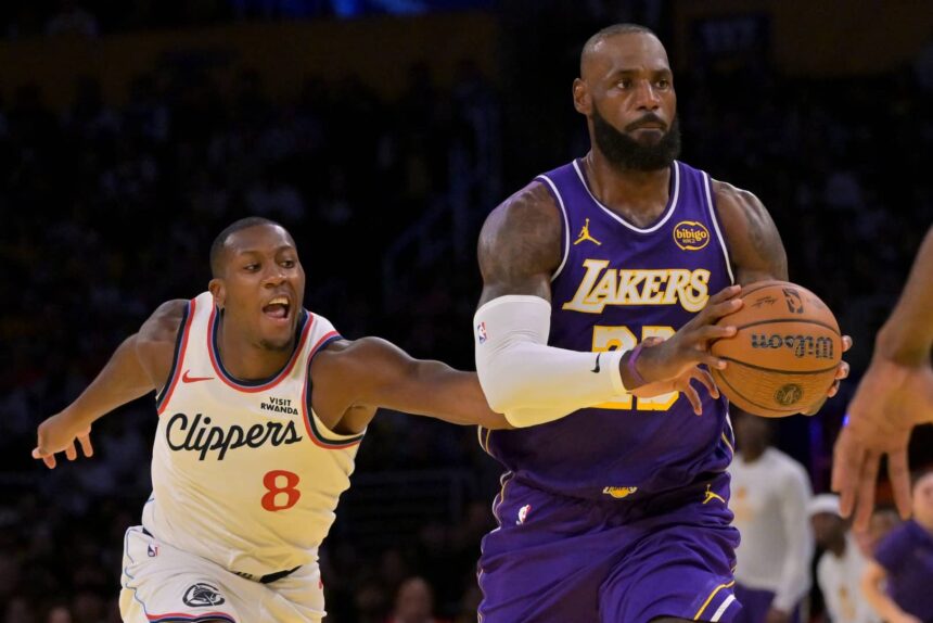 Los Angeles Lakers forward LeBron James (23) drives past Los Angeles Clippers guard Kris Dunn (8) during the first half at Crypto.com Arena.