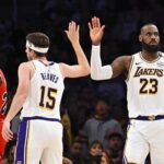 Mar 22, 2025; Los Angeles, California, USA; Los Angeles Lakers forward LeBron James (23) fives guard Austin Reaves (15) after scoring against the Chicago Bulls during the second half at Crypto.com Arena. Mandatory Credit: Jonathan Hui-Imagn Images