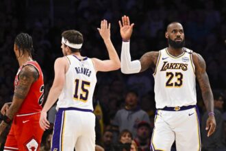 Mar 22, 2025; Los Angeles, California, USA; Los Angeles Lakers forward LeBron James (23) fives guard Austin Reaves (15) after scoring against the Chicago Bulls during the second half at Crypto.com Arena. Mandatory Credit: Jonathan Hui-Imagn Images