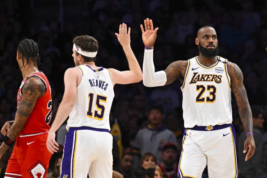 Mar 22, 2025; Los Angeles, California, USA; Los Angeles Lakers forward LeBron James (23) fives guard Austin Reaves (15) after scoring against the Chicago Bulls during the second half at Crypto.com Arena. Mandatory Credit: Jonathan Hui-Imagn Images