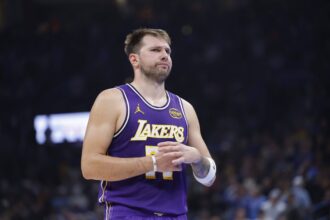 Los Angeles Lakers guard Luka Doncic reacts to a fan during the second quarter of a game against the Oklahoma City Thunder at Paycom Center.