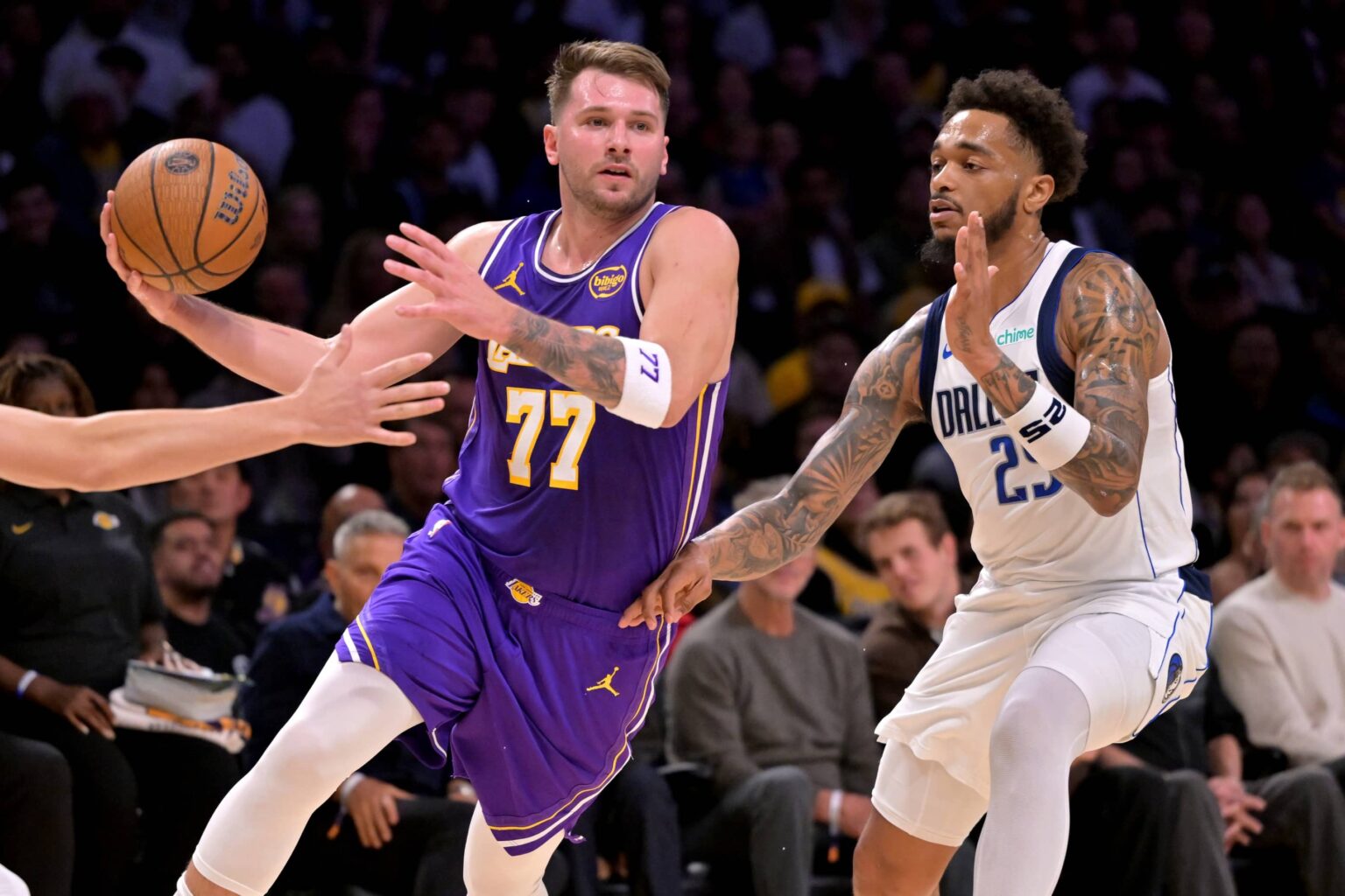 Los Angeles Lakers guard Luka Doncic (77) is defended by Dallas Mavericks forward P.J. Washington (25) as he drives to the basket in the first half at Crypto.com Arena.
