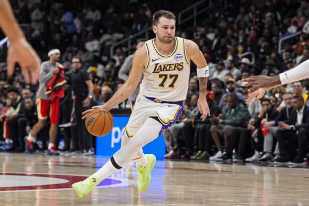 Los Angeles Lakers guard Luka Doncic (77) dribbles against the Atlanta Hawks during the first half at State Farm Arena.