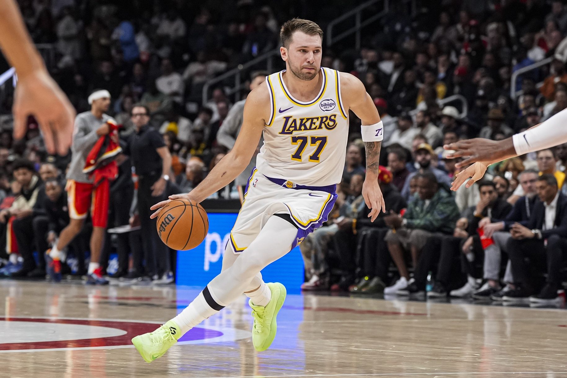 Los Angeles Lakers guard Luka Doncic (77) dribbles against the Atlanta Hawks during the first half at State Farm Arena.