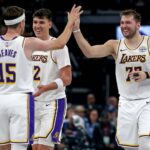 Los Angeles Lakers guard Luka Doncic (77) reacts with guard Austin Reaves (15) during a timeout during the second quarter against the Memphis Grizzlies at FedExForum.