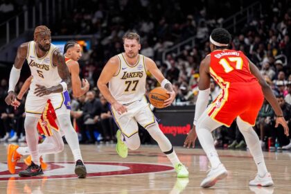 Nov 8, 2025; Atlanta, Georgia, USA; Los Angeles Lakers guard Luka Doncic (77) dribbles against the Atlanta Hawks during the first half at State Farm Arena. Mandatory Credit: Dale Zanine-Imagn Images