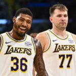 Los Angeles Lakers guard Marcus Smart (36) reacts with Los Angeles Lakers guard Luka Doncic (77) during a time out against the Miami Heat during the second half at Crypto.com Arena.