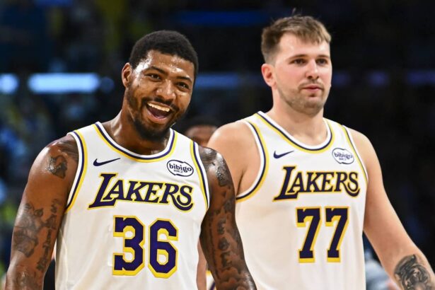 Los Angeles Lakers guard Marcus Smart (36) reacts with Los Angeles Lakers guard Luka Doncic (77) during a time out against the Miami Heat during the second half at Crypto.com Arena.