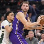 Los Angeles Lakers guard Luka Doncic (77) looks to pass the ball as Milwaukee Bucks guard Ryan Rollins (13) defends during the fourth quarter at Fiserv Forum.