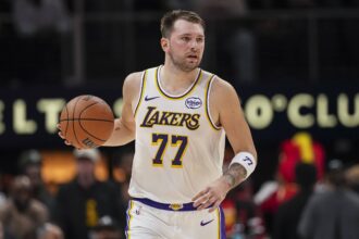 Los Angeles Lakers guard Luka Doncic (77) controls the ball against the Atlanta Hawks during the first half at State Farm Arena.