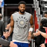 Detroit Pistons guard Malik Beasley (5) greets fans as he takes the court for pregame warmups before their game against the Houston Rockets at Little Caesars Arena. Mandatory Credit: Lon Horwedel-Imagn Images