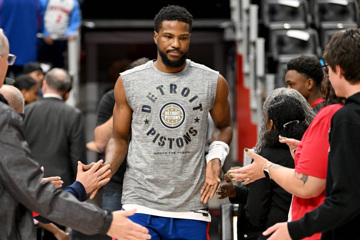Detroit Pistons guard Malik Beasley (5) greets fans as he takes the court for pregame warmups before their game against the Houston Rockets at Little Caesars Arena. Mandatory Credit: Lon Horwedel-Imagn Images