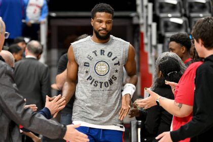 Detroit Pistons guard Malik Beasley (5) greets fans as he takes the court for pregame warmups before their game against the Houston Rockets at Little Caesars Arena. Mandatory Credit: Lon Horwedel-Imagn Images