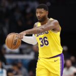 Nov 10, 2025; Charlotte, North Carolina, USA; Los Angeles Lakers guard Marcus Smart (36) directs the offense during the second quarter against the Charlotte Hornets at Spectrum Center. Mandatory Credit: Brian Westerholt-Imagn Images