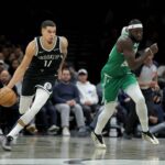 Brooklyn Nets forward Michael Porter Jr. (17) brings the ball up court against Boston Celtics center Neemias Queta (88) during the fourth quarter at Barclays Center.