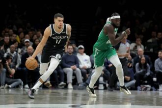 Brooklyn Nets forward Michael Porter Jr. (17) brings the ball up court against Boston Celtics center Neemias Queta (88) during the fourth quarter at Barclays Center.