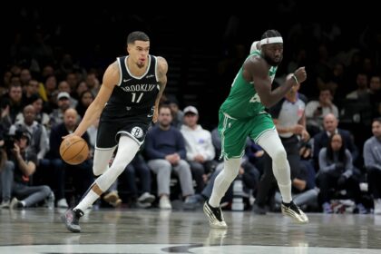 Brooklyn Nets forward Michael Porter Jr. (17) brings the ball up court against Boston Celtics center Neemias Queta (88) during the fourth quarter at Barclays Center.