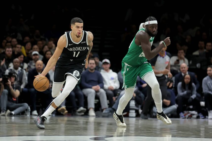 Brooklyn Nets forward Michael Porter Jr. (17) brings the ball up court against Boston Celtics center Neemias Queta (88) during the fourth quarter at Barclays Center.