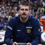 Denver Nuggets center Nikola Jokic (15) on the bench in the third quarter at Ball Arena.