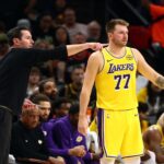Oct 14, 2025; Phoenix, Arizona, USA; Los Angeles Lakers guard Luka Doncic (77) with head coach JJ Redick against the Phoenix Suns during an NBA preseason game at Mortgage Matchup Center. Mandatory Credit: Mark J. Rebilas-Imagn Images