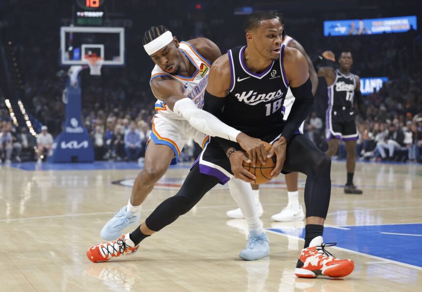 Oklahoma City Thunder guard Shai Gilgeous-Alexander (2) defends a drive by Sacramento Kings guard Russell Westbrook (18) during the first quarter at Paycom Center.