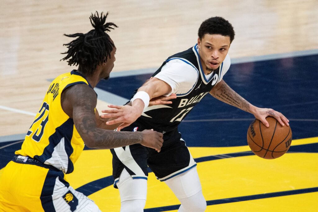 Milwaukee Bucks guard Ryan Rollins (13) dribbles against Indiana Pacers guard Quenton Jackson (29) in the first half at Gainbridge Fieldhouse.