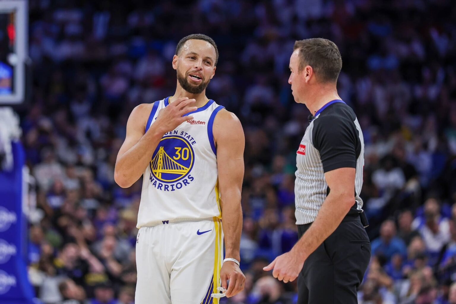 Golden State Warriors guard Stephen Curry (30) talks with referee Josh Tiven (58) during the second quarter against the Orlando Magic at Kia Center.