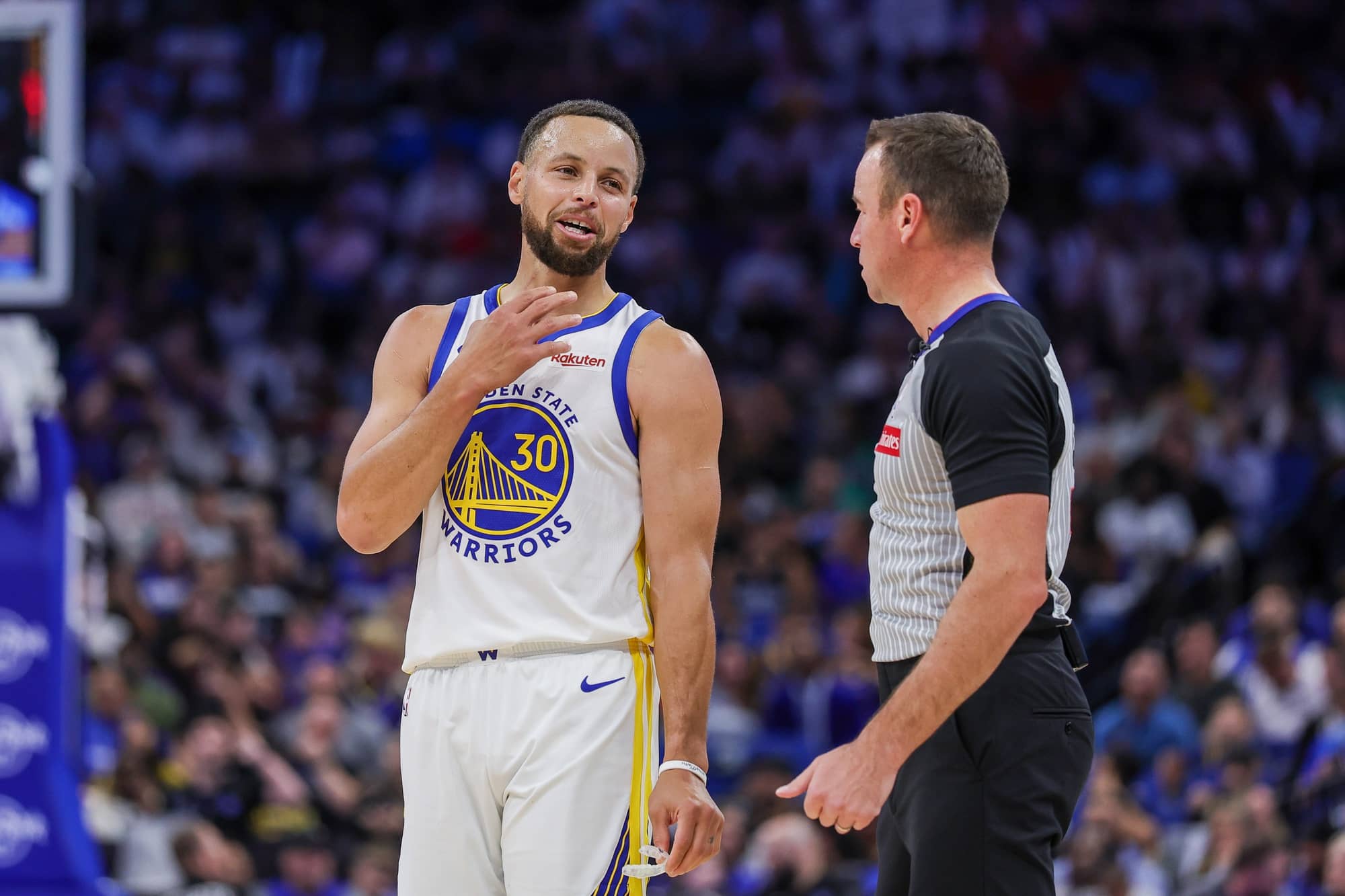 Golden State Warriors guard Stephen Curry (30) talks with referee Josh Tiven (58) during the second quarter against the Orlando Magic at Kia Center.
