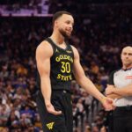Golden State Warriors guard Stephen Curry (30) talks to the Houston Rockets bench during a break in the action in the third quarter at Chase Center.