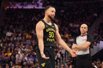 Golden State Warriors guard Stephen Curry (30) talks to the Houston Rockets bench during a break in the action in the third quarter at Chase Center.