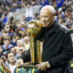 Oct 5, 2018; Seattle, WA, USA; Former Seattle Supersonics head coach Lenny Wilkens holds the 1979 championship trophy during a third quarter timeout of a game between the Sacramento Kings and Golden State Warriors at KeyArena. Mandatory Credit: Joe Nicholson-Imagn Images