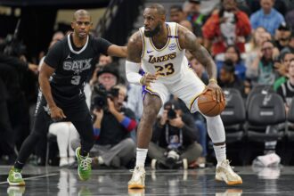 San Antonio, Texas, USA; Los Angeles Lakers forward LeBron James (23) looks to pass the ball while defended by San Antonio Spurs guard Chris Paul (3) during the first half during the first half at Frost Bank Center. Mandatory Credit: Scott Wachter-Imagn Images