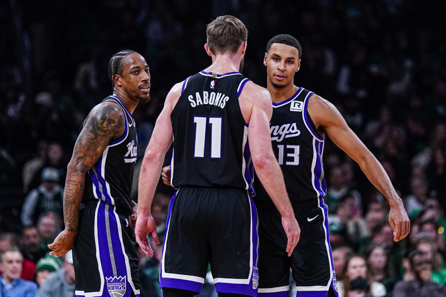 Jan 10, 2025; Boston, Massachusetts, USA; Sacramento Kings forward DeMar DeRozan (10), forward Keegan Murray (13) and forward Domantas Sabonis (11) react after defeating the Boston Celtics at TD Garden. Mandatory Credit: David Butler II-Imagn Images