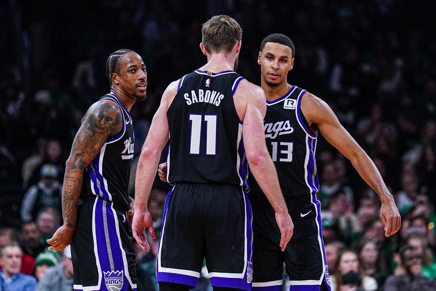 Jan 10, 2025; Boston, Massachusetts, USA; Sacramento Kings forward DeMar DeRozan (10), forward Keegan Murray (13) and forward Domantas Sabonis (11) react after defeating the Boston Celtics at TD Garden. Mandatory Credit: David Butler II-Imagn Images