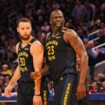 Feb 3, 2025; San Francisco, California, USA; Golden State Warriors guard Stephen Curry (30) and forward Draymond Green (23) look towards an Orlando Magic player at half time at Chase Center. Mandatory Credit: Kelley L Cox-Imagn Images
