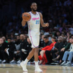 Feb 10, 2025; Miami, Florida, USA; Miami Heat forward Andrew Wiggins (22) dribbles the basketball against the Boston Celtics during the second quarter at Kaseya Center. Mandatory Credit: Sam Navarro-Imagn Images