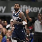 Feb 12, 2025; Dallas, Texas, USA; Dallas Mavericks guard Kyrie Irving (11) smiles after he makes a basket against the Golden State Warriors during the second quarter at the American Airlines Center. Mandatory Credit: Jerome Miron-Imagn Images