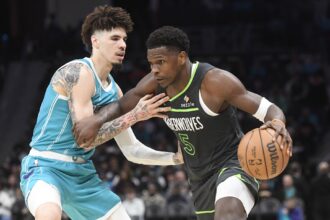 Mar 5, 2025; Charlotte, North Carolina, USA; Minnesota Timberwolves guard Anthony Edwards (5) drives past Charlotte Hornets guard LaMelo Ball (1) during the second half at the Spectrum Center. Mandatory Credit: Sam Sharpe-Imagn Images