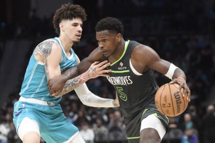 Mar 5, 2025; Charlotte, North Carolina, USA; Minnesota Timberwolves guard Anthony Edwards (5) drives past Charlotte Hornets guard LaMelo Ball (1) during the second half at the Spectrum Center. Mandatory Credit: Sam Sharpe-Imagn Images