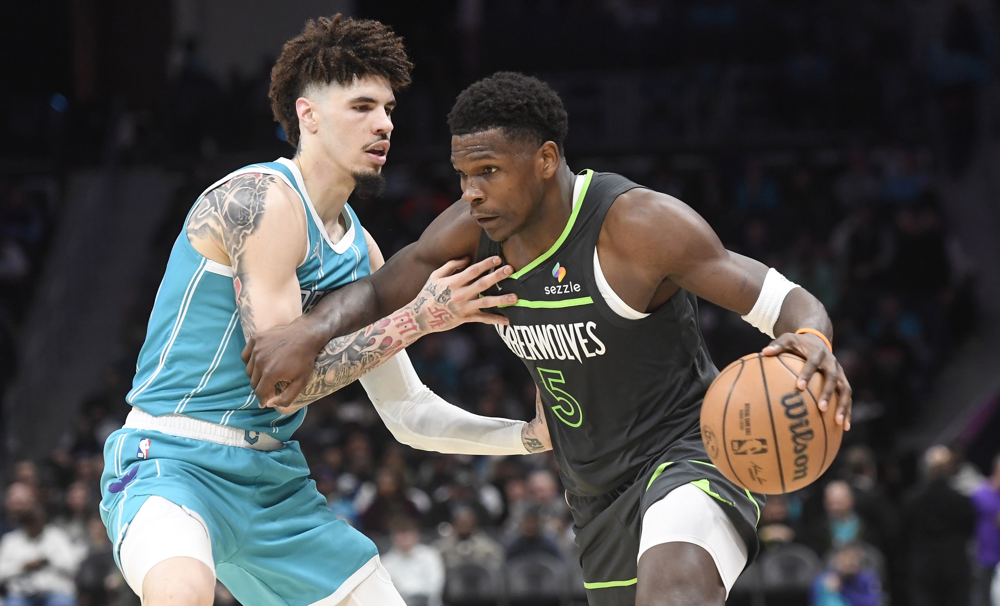 Mar 5, 2025; Charlotte, North Carolina, USA; Minnesota Timberwolves guard Anthony Edwards (5) drives past Charlotte Hornets guard LaMelo Ball (1) during the second half at the Spectrum Center. Mandatory Credit: Sam Sharpe-Imagn Images