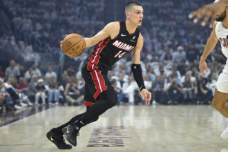 Cleveland, Ohio, USA; Miami Heat guard Tyler Herro (14) dribbles against the Cleveland Cavaliers in the first quarter of game two of the first round of the 2025 NBA Playoffs at Rocket Arena. Mandatory Credit: David Richard-Imagn Images