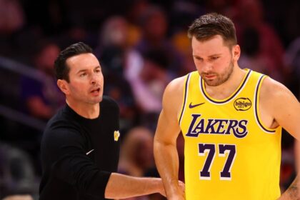 Los Angeles Lakers guard Luka Doncic (77) with head coach JJ Redick against the Phoenix Suns during an NBA preseason game at Mortgage Matchup Center.