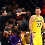 Oct 14, 2025; Phoenix, Arizona, USA; Los Angeles Lakers guard Luka Doncic (77) with head coach JJ Redick against the Phoenix Suns during an NBA preseason game at Mortgage Matchup Center. Mandatory Credit: Mark J. Rebilas-Imagn Images