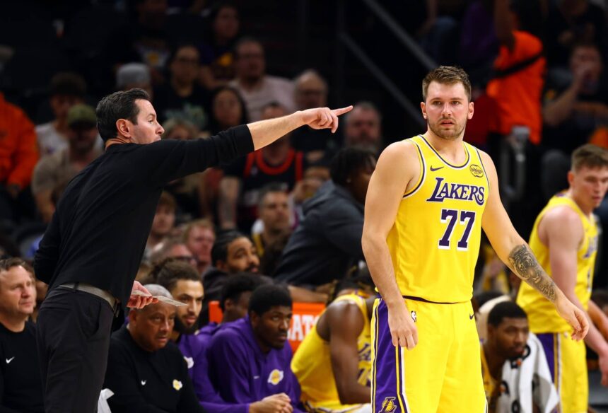 Oct 14, 2025; Phoenix, Arizona, USA; Los Angeles Lakers guard Luka Doncic (77) with head coach JJ Redick against the Phoenix Suns during an NBA preseason game at Mortgage Matchup Center. Mandatory Credit: Mark J. Rebilas-Imagn Images