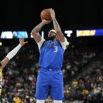 Oct 15, 2025; Las Vegas, Nevada, USA; Dallas Mavericks forward Anthony Davis (3) shoots the ball against Los Angeles Lakers guard R.J. Davis (55) during the first half at T-Mobile Arena. Mandatory Credit: Lucas Peltier-Imagn Images