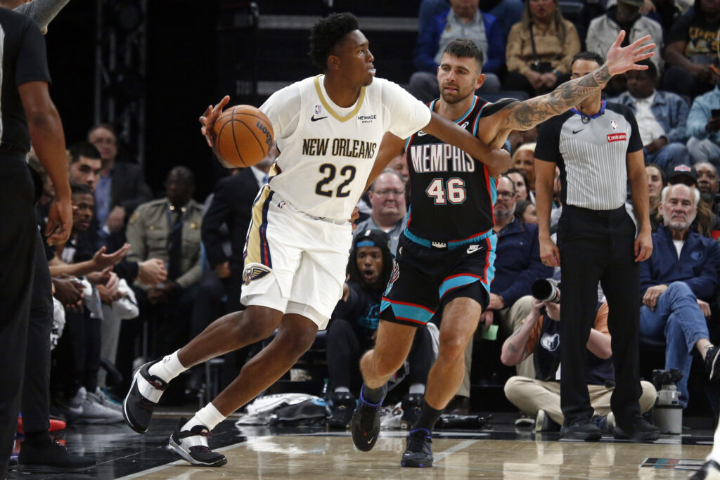 Oct 22, 2025; Memphis, Tennessee, USA; New Orleans Pelicans center Derik Queen (22) dribbles as Memphis Grizzlies John Konchar (46) defends during the second quarter at FedExForum. Mandatory Credit: Petre Thomas-Imagn Images